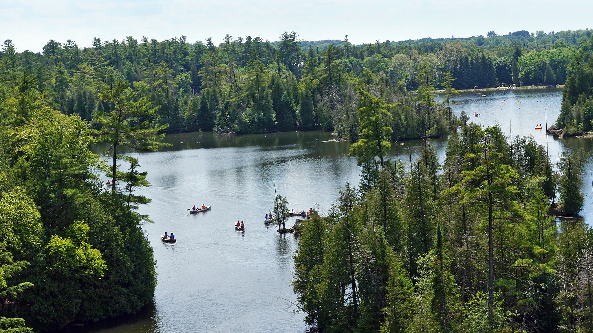 Aerial view of Rockwood on a summer day with several canoes and kayaks on the water.